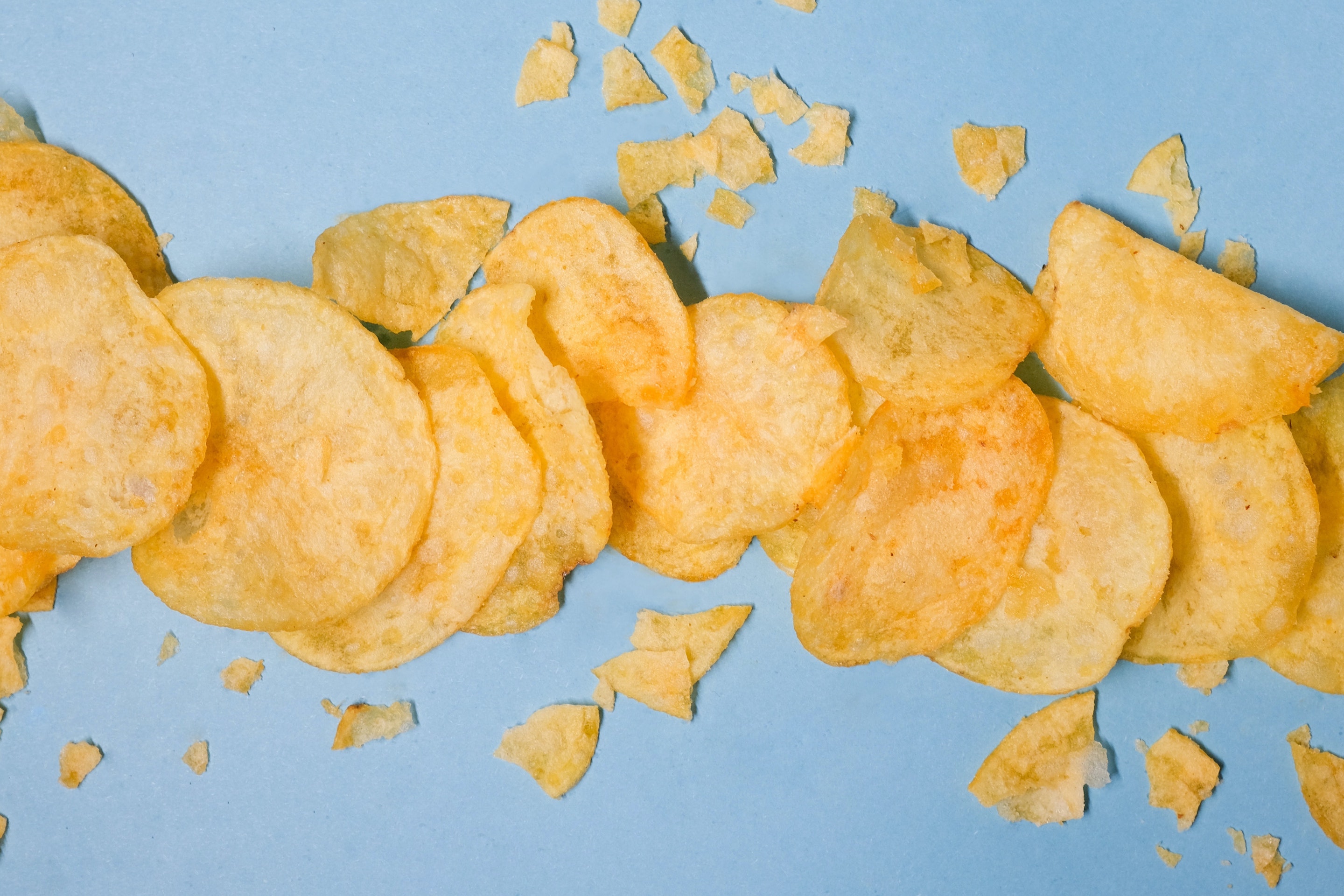 Potato chips on blue background